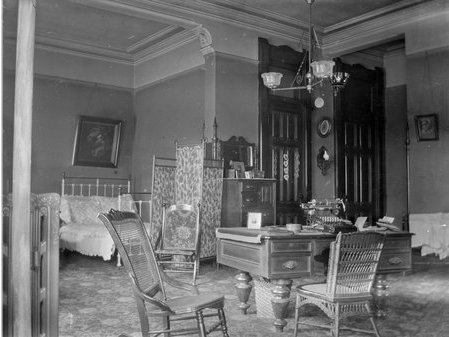 Large bedroom with a table and chairs