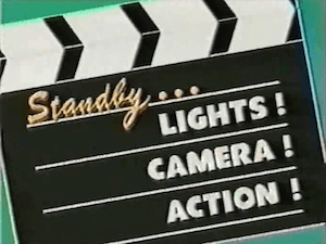 Standby...Lights! Camera! Action! title card.png