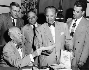 Dave Jones hands Arthur McBride a check, 1953