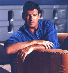 Pierce Brosnan sitting in Pacific Green sofa