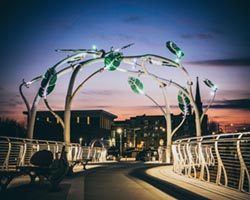 The Blain Gilbertson Family Heritage Bridge featuring the Resilience sculpture in Downtown Janesville's Town Square.