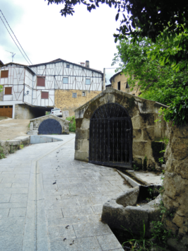 A village medieval street with traditional houses at the background