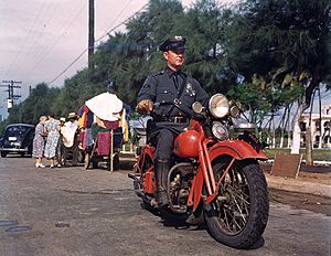 Policeman inspecting rugs, Puerto Rico (8364088239)