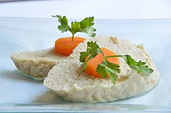 Gefilte fish topped with slices of carrot.jpg