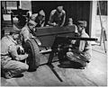 Crew of 37mm. anti-tank gun, in training at Fort Benning, Georgia, clean and adjust their weapon. - NARA - 196275