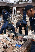 US Navy 050905-N-0000X-003 U.S. Navy Sailors, assigned to the amphibious transport dock USS Shreveport (LPD 12), perform a search and rescue mission following Hurricane Katrina in Biloxi, Miss