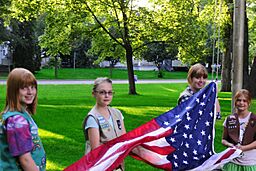 Girl Scouts raising the American flag