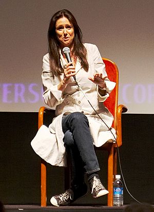 Taymor at press event seated facing camera