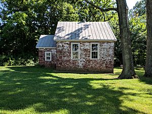 Small old stone building appearing to be one or two rooms.