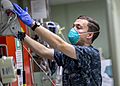 USNS Mercy Sailor Treats Patient (49785699691)