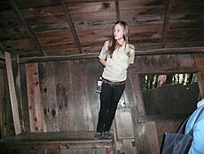 Guide leaning on table at The Mystery Spot