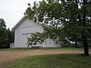 a church partially obscured by a tree