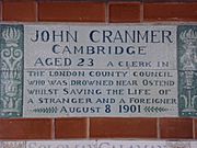 A tablet formed of six standard sized tiles, bordered by green flowers in the style of the Arts and Crafts movement