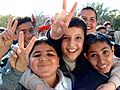 Iraqi boys giving peace sign