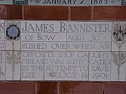 A tablet formed of five tiles of varying sizes, bordered by yellow and blue flowers in an art nouveau style