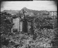 Scene of war damage in residential section of Seoul, Korea. The capitol building can be seen in the background (right). - NARA - 531379