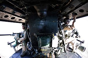 US Navy 071212-M-4213L-014 During flight, the crew chiefs, Sgt. J.R. Murphy, left, and Staff Sgt. B.W. Boroff, both attached to Helicopter Light Attack Squadron (HMLA) 367, look over the horizon with their .50-cal machine gun a