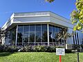 The St. George Temple Visitors Center, with flowers and grass out front. A Sign in the foreground reads: "Temple Open House"