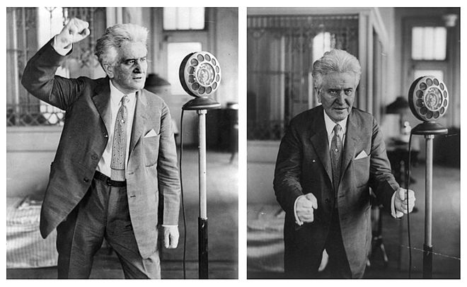 Robert M. La Follette standing before microphone, making oratorical gestures