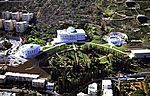 Large white buildings in a landscape garden.