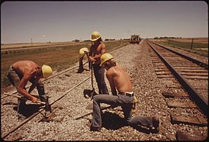 RAILROAD WORK CREW IMPROVES THE TRACKS AND BED OF THE ATCHISON, TOPEKA AND SANTA FE RAILROAD NEAR BELLEFONT, KANSAS... - NARA - 556012