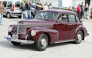 1939 Opel Kapitän, Owner Arild Nilssen who, as his lady companion wear matching attire cropped to highlight the car