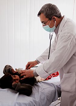 Turkish pediatrician listens to a childs heartbeat in Afghanistan.jpg