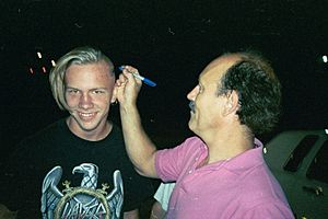 Gallagher signs head of a fan after a show