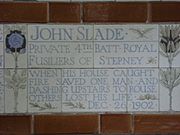 A tablet formed of five tiles of varying sizes, bordered by yellow and blue flowers in an art nouveau style