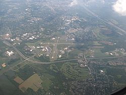 Aerial view of Ewing, looking southeast and featuring Trenton–Mercer Airport, Interstate 295, and the Delaware River