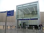 A large two-storey entrance with glazed facade. A sign reading "PADDINGTON STATION" is etched into the glass