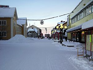 The main street (Storgatan) with snow and Christmas lights in Gällivare at about noon in December 2005.