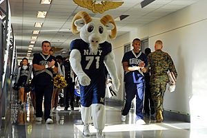 US Navy 081204-N-9858B-047 Members of the U.S. Naval Academy Band parade the halls of the Pentagon in celebration of Army-Navy game