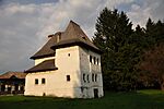 A white tower with a wooden roof