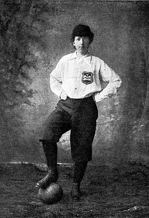 Black and white photo of Matthew wearing a white top with a football under her foot