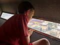 Boy looking out observation window