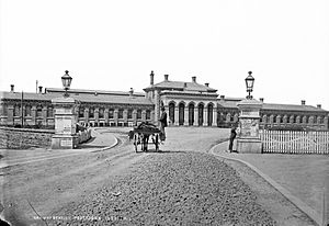 Sticking up posters on the gate piers of Portadown Railway Station