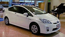 A white Toyota Prius sedan is on display.