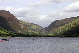 A lake, with a deep ravine between two mountains beyond