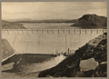 Dam in the foreground and lake with butte in the background