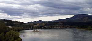 Carmacks is seen from the Yukon River bridge with the river in the foreground.