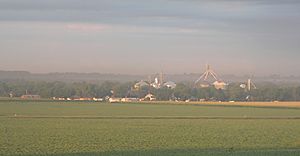 Town with grain elevators; crop field in foreground