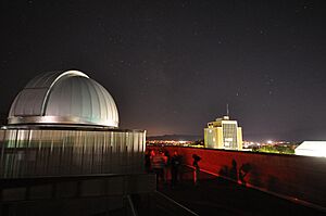 Utah State University observatory and business building at night