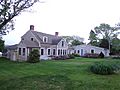 This is a large farmhouse that with a sun room and greenhouse in the back.