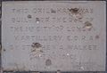 Foundation stone in Shepherds Bush with shrapnel damage