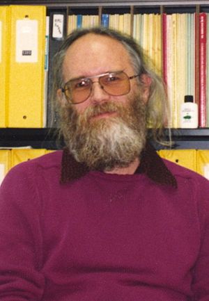 Jon Postel sitting in office (cropped).jpg