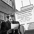 Marcelle Lestrange looks at her permit for Utility furniture which she has just received from Chelsea Borough Council in March 1943. D12855