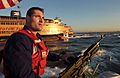 US Navy 040901-C-7087B-001 Petty Officer 3rd Class Maurice Orlando, from San Diego, Calif., keeps a sharp eye on boat traffic while security boats from Coast Guard Maritime Safety and Security Team 91106 escort Staten Island fe