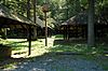 Three rustic picnic shelters in a forest