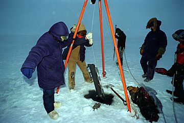 Researchers using Niskin bottle to collect water sample · DN-SD-01-00282